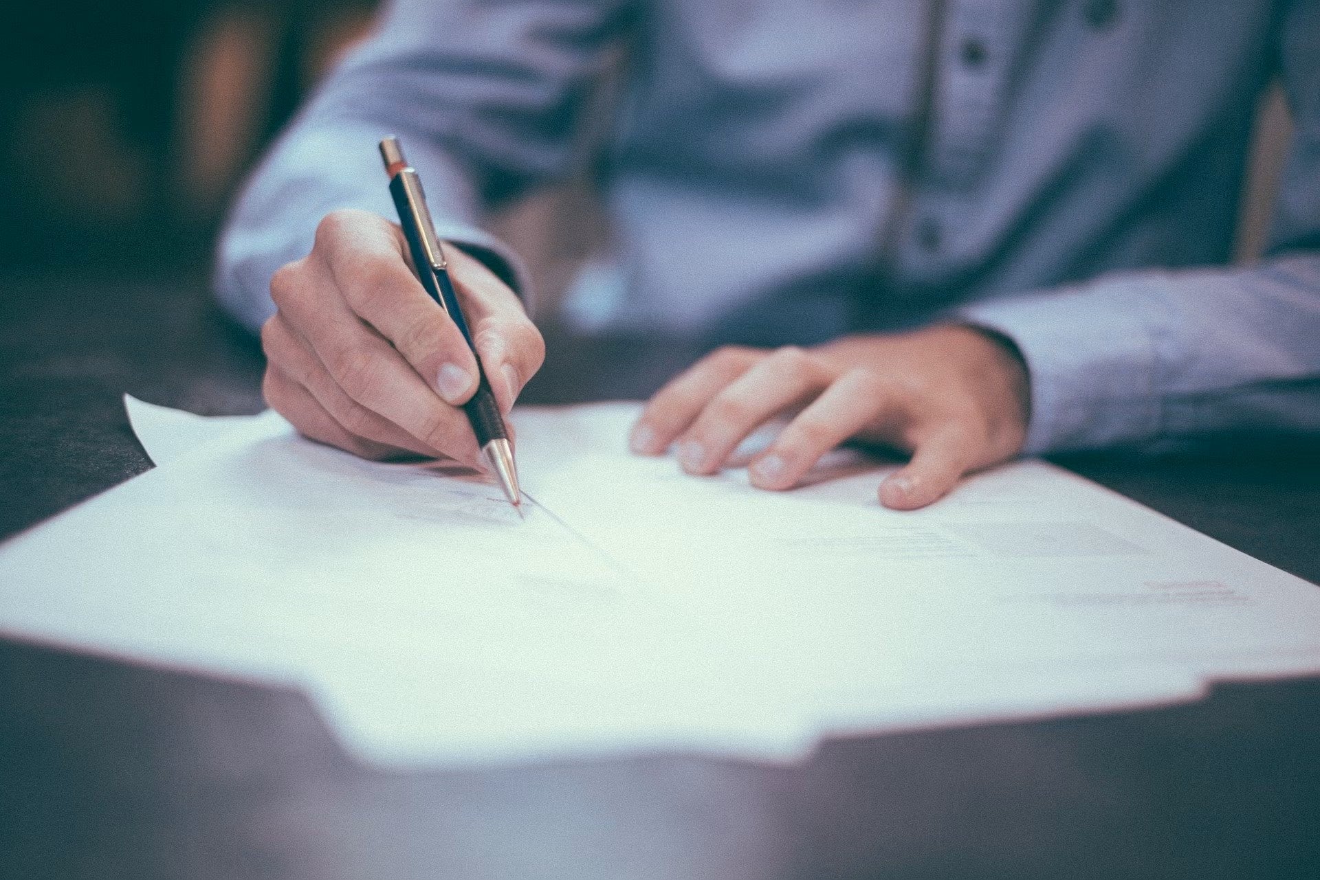 Person filling out paperwork